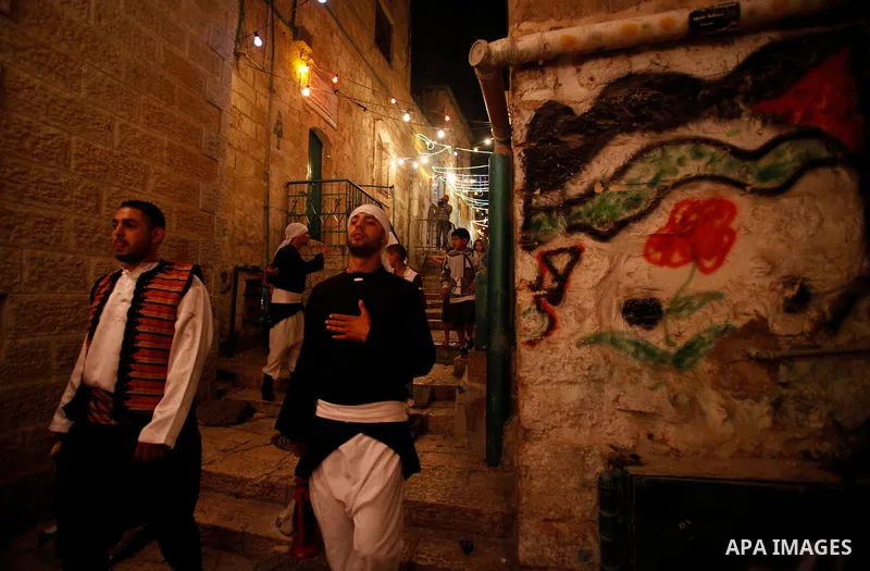 Palestinian dawn awakeners, al-Musaharati in Arabic, walk through streets to wake up Muslims for a meal before sunrise during the fasting month of Ramadan, in Jerusalem's old city on July 13, 2013. Al-Musaharati is an ol...