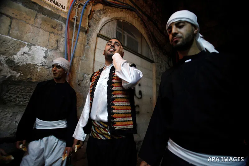 Palestinian dawn awakeners, al-Musaharati in Arabic, walk through streets to wake up Muslims for a meal before sunrise during the fasting month of Ramadan, in Jerusalem's old city on July 13, 2013. Al-Musaharati is an ol...