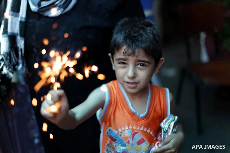 A Palestinian boy plays with fireworks on the fourth day of the Muslim fasting month of Ramadan on July 13, 2013 in Gaza city. During Ramadan, one of the five main religious obligations under Islam, Muslims are required...
