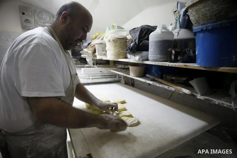 A Palestinian man prepares traditional sweets "Baklava" during the fourth day of the holy fasting month of Ramadan, in Jerusalem old city, on July 13, 2013. Muslims around the world are observing the holy fasting month o...