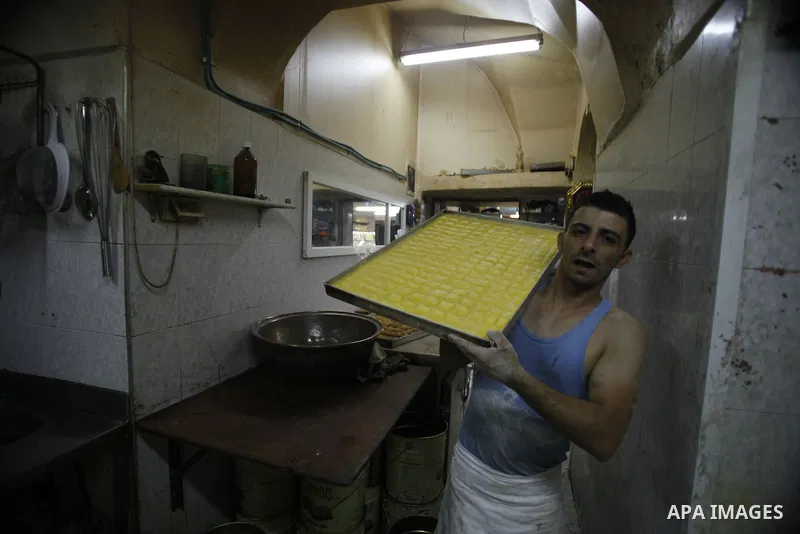 A Palestinian man prepares traditional sweets "Baklava" during the fourth day of the holy fasting month of Ramadan, in Jerusalem old city, on July 13, 2013. Muslims around the world are observing the holy fasting month o...