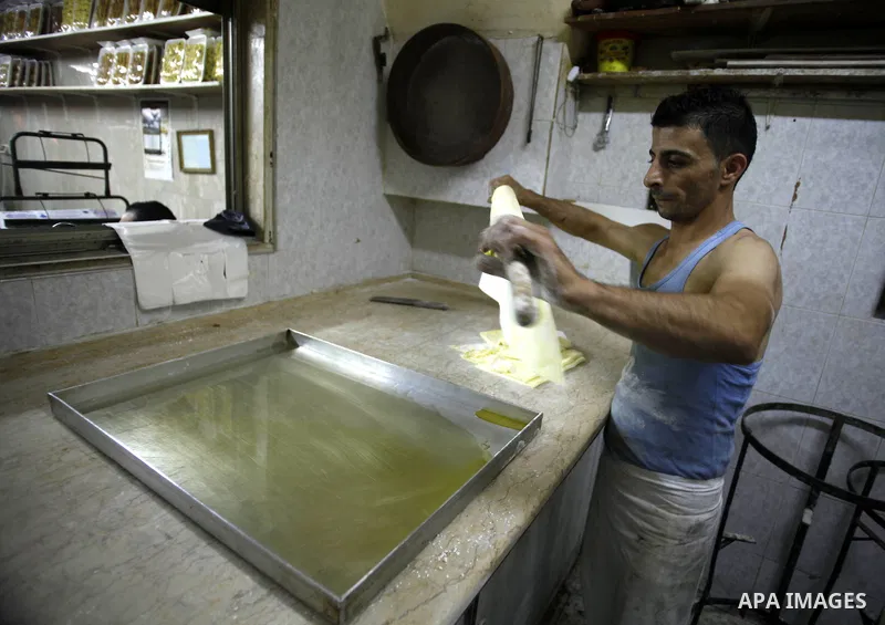 A Palestinian man prepares traditional sweets "Baklava" during the fourth day of the holy fasting month of Ramadan, in Jerusalem old city, on July 13, 2013. Muslims around the world are observing the holy fasting month o...