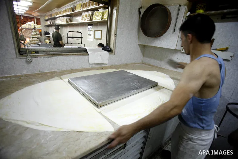 A Palestinian man prepares traditional sweets "Baklava" during the fourth day of the holy fasting month of Ramadan, in Jerusalem old city, on July 13, 2013. Muslims around the world are observing the holy fasting month o...