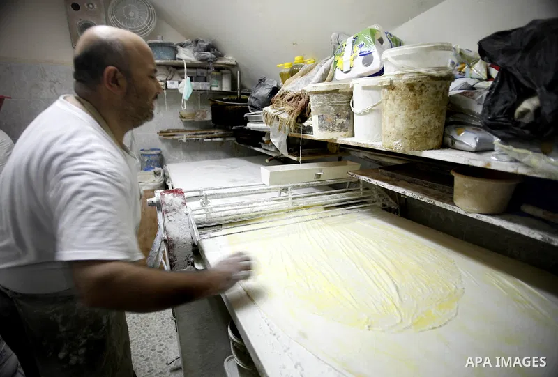 A Palestinian man prepares traditional sweets "Baklava" during the fourth day of the holy fasting month of Ramadan, in Jerusalem old city, on July 13, 2013. Muslims around the world are observing the holy fasting month o...