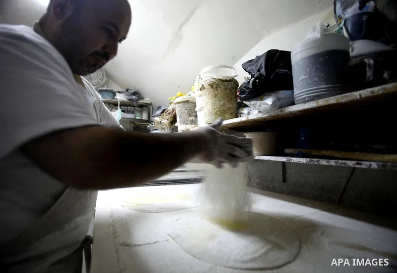 A Palestinian man prepares traditional sweets "Baklava" during the fourth day of the holy fasting month of Ramadan, in Jerusalem old city, on July 13, 2013. Muslims around the world are observing the holy fasting month o...