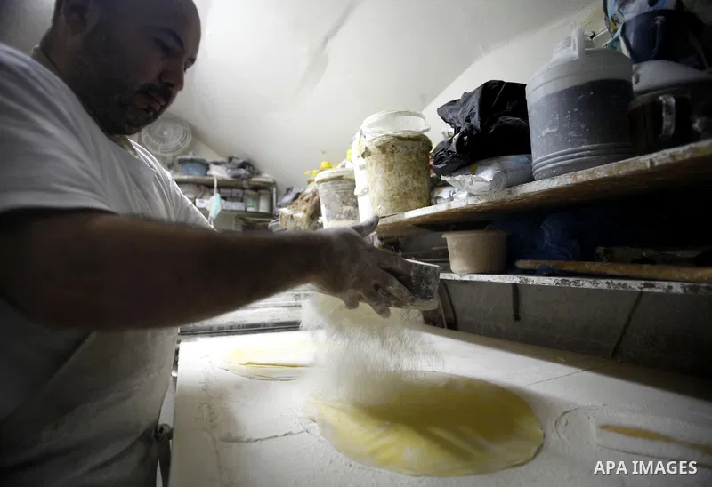 A Palestinian man prepares traditional sweets "Baklava" during the fourth day of the holy fasting month of Ramadan, in Jerusalem old city, on July 13, 2013. Muslims around the world are observing the holy fasting month o...