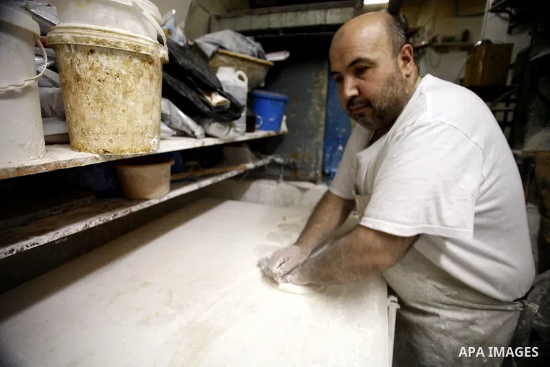A Palestinian man prepares traditional sweets "Baklava" during the fourth day of the holy fasting month of Ramadan, in Jerusalem old city, on July 13, 2013. Muslims around the world are observing the holy fasting month o...