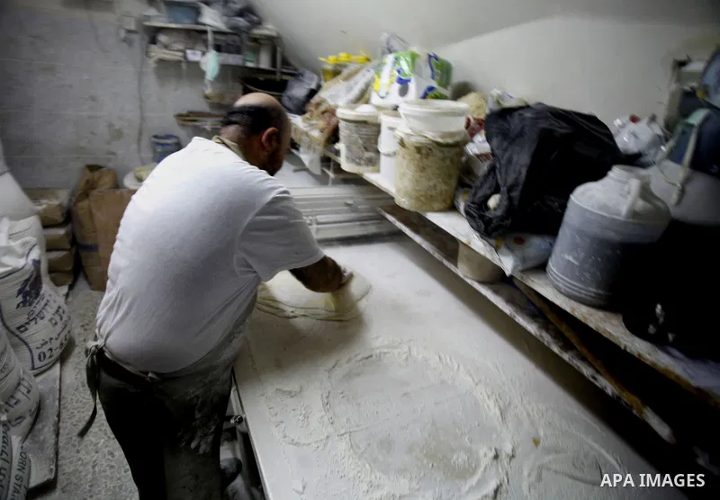 A Palestinian man prepares traditional sweets "Baklava" during the fourth day of the holy fasting month of Ramadan, in Jerusalem old city, on July 13, 2013. Muslims around the world are observing the holy fasting month o...