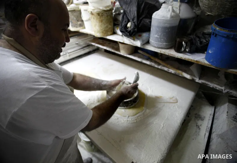 A Palestinian man prepares traditional sweets "Baklava" during the fourth day of the holy fasting month of Ramadan, in Jerusalem old city, on July 13, 2013. Muslims around the world are observing the holy fasting month o...