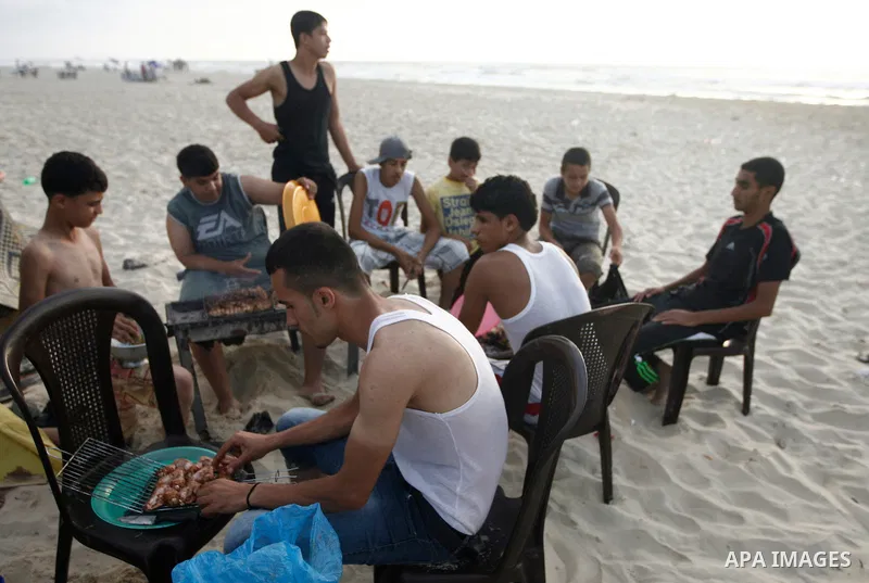 Palestinians prepare their breakfast at the beach during the holy fasting month of Ramadan, in Gaza city on July 13, 2013. During Ramadan, muslims around the world are observing the holy fasting month of Ramadan in which...