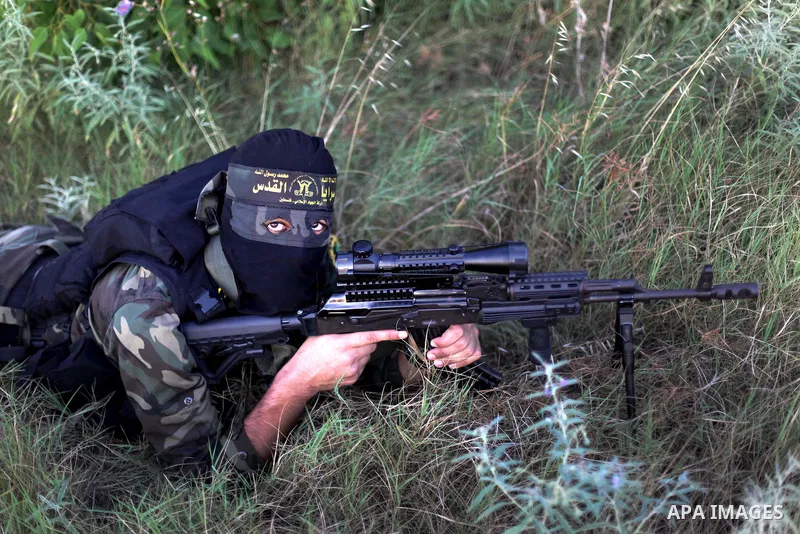 Masked militants from al-Quds Brigades the armed wing of the Islamic Jihad organization, guard the eastern border of Gaza City, on July 15, 2013. Photo by Ashraf Amra