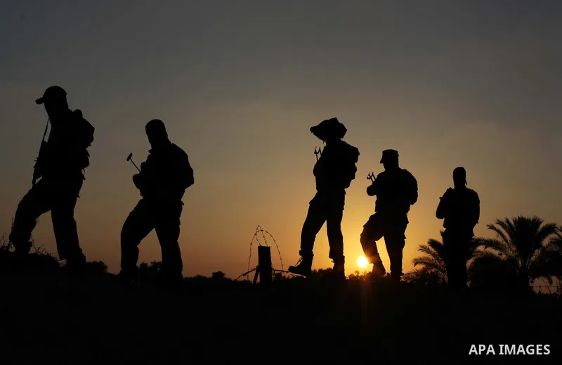 Masked militants from al-Quds Brigades the armed wing of the Islamic Jihad organization, guard the eastern border of Gaza City, on July 15, 2013. Photo by Ashraf Amra