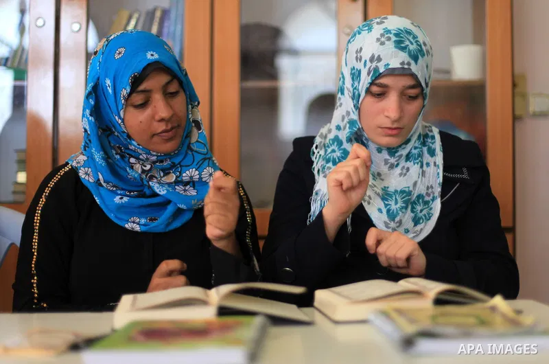 Palestinian deaf girls take part in Quran memorizing camp named 'We are rising by Quran', in Gaza city on July 18, 2013. Photo by Ashraf Amra