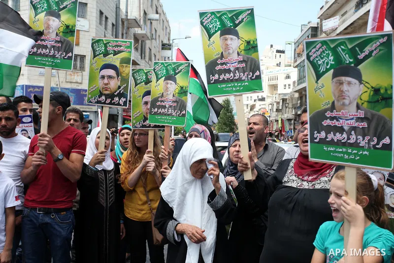 Palestinian protesters holds pictures of Jordanian prisoners in Israeli jails demanding for their release in the West Bank city of Ramallah, July 18, 2013. Protesters denounced the ''official silence'' towards the issue...