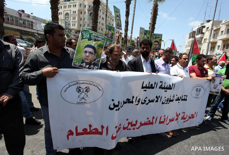 Palestinian protesters holds pictures of Jordanian prisoners in Israeli jails demanding for their release in the West Bank city of Ramallah, July 18, 2013. Protesters denounced the ''official silence'' towards the issue...