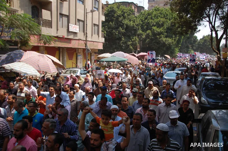 Supporters of the Muslim Brotherhood attend a protest in support of ousted President Mohamed Morsi outside the Rabaa al-Adawiya mosque in Cairo, Egypt, 19 July 2013. The supporters were demanding the restoration of the o...