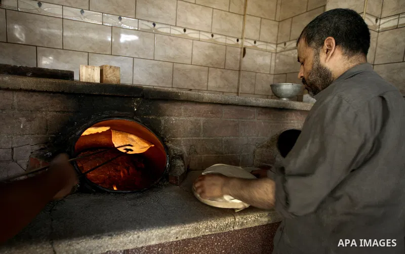 A Palestinian baker prepares flatbread at his traditional bakery, during the Muslim fasting month of Ramadan, in Gaza city on July 20, 2013. During Ramadan, one of the five main religious obligations under Islam, Muslims...