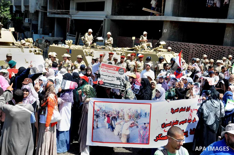 Supporters of ousted Egyptian President Mohammed Morsi march through the residential neighborhood of Garden City, passing several diplomatic missions, but avoiding the U.S. embassy, in Cairo, Egypt, Saturday, July 21, 20...