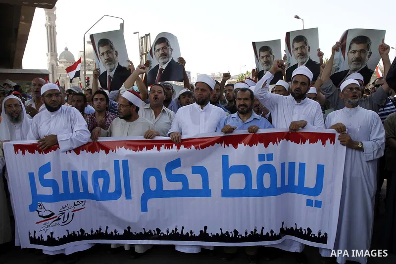 Members of the Muslim Brotherhood and supporters of ousted Egyptian President Mohamed Mursi shout slogans during a demonstration outside al-Noor mosque in Cairo July 22, 2013. The family of ousted Egyptian President Moha...