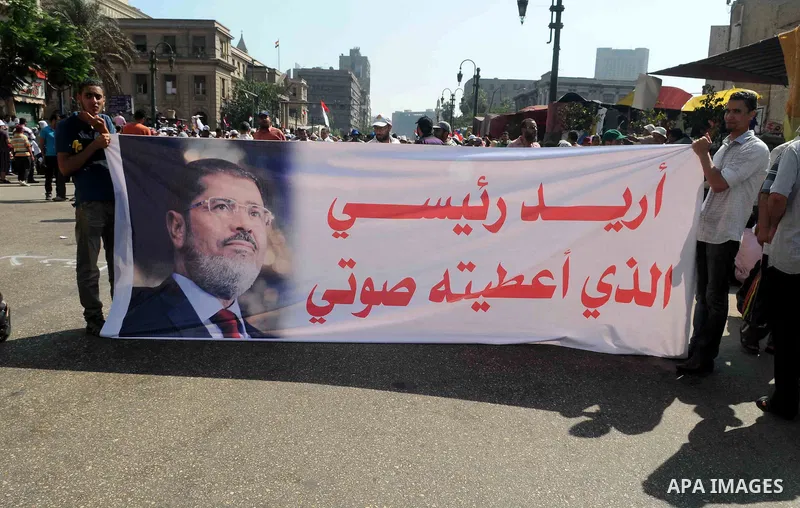 Members of the Muslim Brotherhood and supporters of ousted Egyptian President Mohamed Mursi shout slogans in front of the courthouse and the Attorney General's office during a demonstration in Cairo July 22, 2013. The fa...