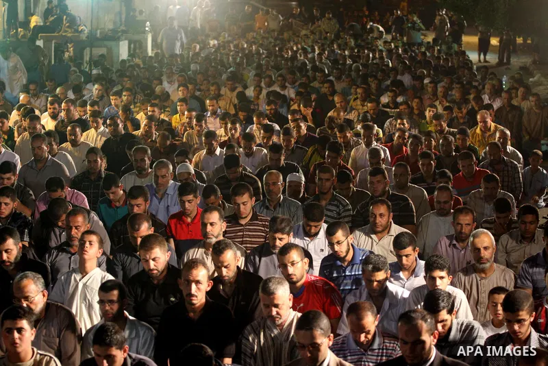 Palestinian Prime Minister in Gaza Ismail Haniyeh leads a night prayer known as "Tarawih" during a rally to show solidarity with Palestinian prisoners inside Israeli jails, in Gaza City July 22, 2013. According to a Pale...