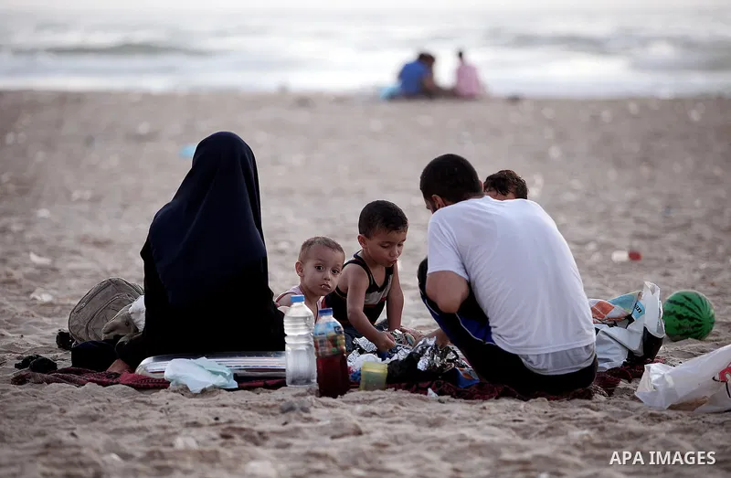 Palestinian Families break their fasting at the beach during the holy fasting month of Ramadan, in Gaza city on July 22, 2013. During Ramadan, muslims around the world are observing the holy fasting month of Ramadan in w...