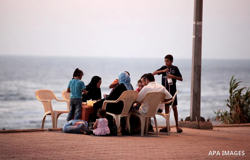 Palestinian Families break their fasting at the beach during the holy fasting month of Ramadan, in Gaza city on July 22, 2013. During Ramadan, muslims around the world are observing the holy fasting month of Ramadan in w...