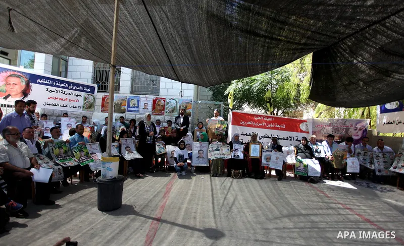 Palestinian protesters holds pictures of Jordanian prisoners in Israeli jails demanding for their release in the West Bank city of Ramallah, July 23, 2013. Protesters denounced the "official silence" towards the issue of...