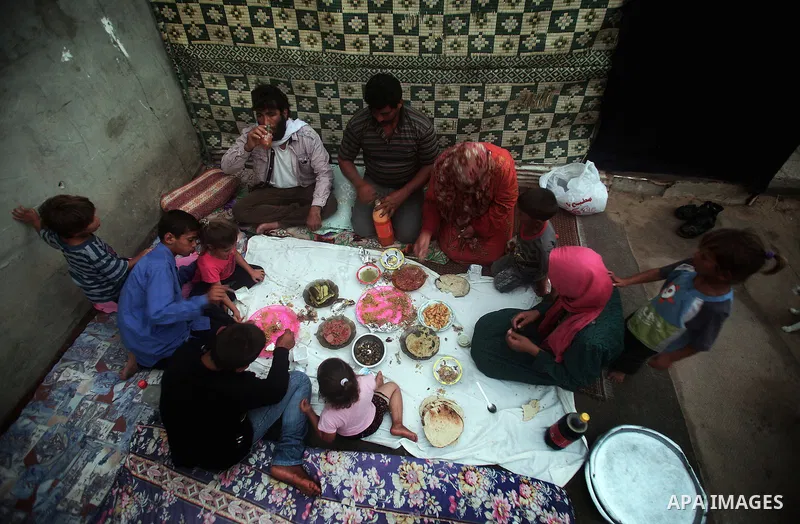 A Palestinian refugee family break their fasting at their home in one of the poorest regions in Beit Lahia town during the Holy month of Ramadan, northern Gaza Strip, 24 July 2013. Muslims throughout the world are celebr...