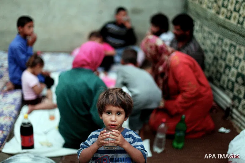 A Palestinian refugee family break their fasting at their home in one of the poorest regions in Beit Lahia town during the Holy month of Ramadan, northern Gaza Strip, 24 July 2013. Muslims throughout the world are celebr...