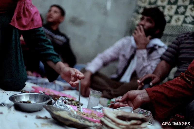 A Palestinian refugee family break their fasting at their home in one of the poorest regions in Beit Lahia town during the Holy month of Ramadan, northern Gaza Strip, 24 July 2013. Muslims throughout the world are celebr...