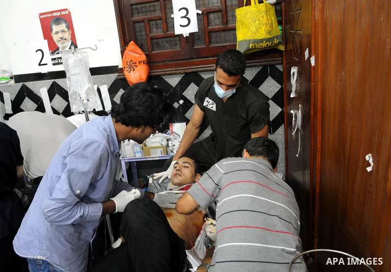 An injured supporter of the deposed Egyptian President Mohamed Morsi receives medical treatment in a makeshift hospital after clashes with riot policemen in Cairo, Egypt, early on July 27, 2013. The death toll of clashes...