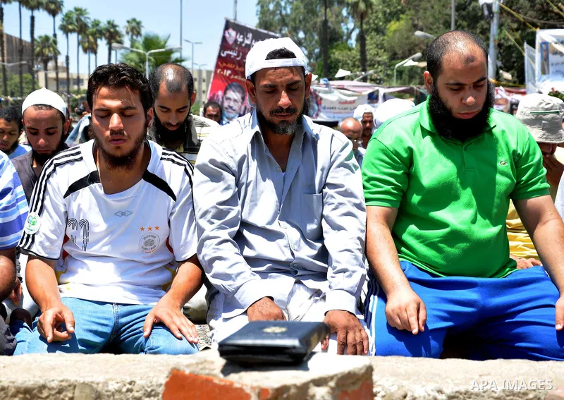 Supporters of the Muslim Brotherhood pray take part in a protest in support of ousted president Mohamed Morsi, at al-Nahda square near Cairo, Egypt, July 29, 2013. Deadly clashes broke out during funerals of slain suppor...