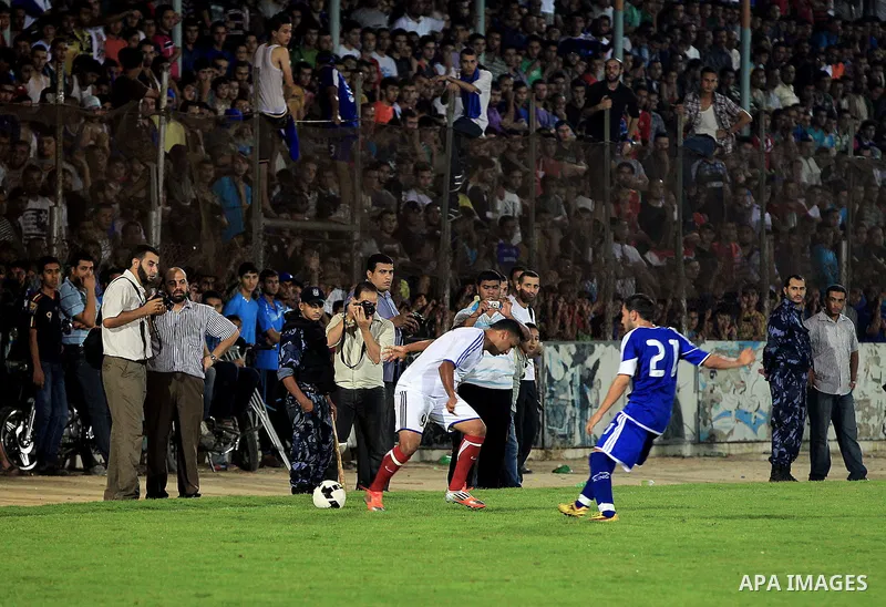 Palestinian soccer teams from Gaza City's al-Shati Services football club compete for the Pepsi cup league against Rafah Youth Club in Al-Yarmouk Stadium in Gaza City on July 29, 2013. al-Shati Services club beat off Raf...