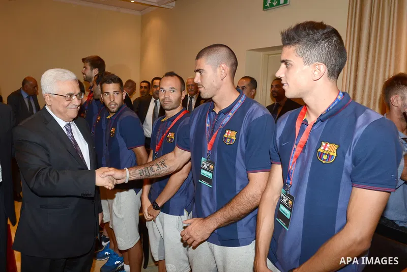 Palestinian President Mahmoud Abbas (Abu Mazen) meets with the Barcelona players in the West Bank city of Bethlehem, 03 August 2013. Photo by Thaer Ghanaim