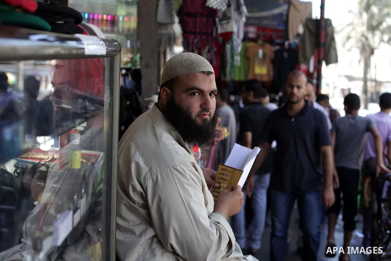 Palestinians shop at a market during preparations for the Eid Al-Fitr feast Gaza city on Aug 06, 2013, as Muslims over the world prepare to celebrate Eid al-Fitr, a three day holiday marking the end of the religious mont...