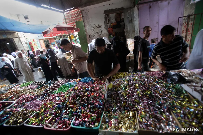A Palestinian vendor displays chocolate during preparations for the Eid Al-Fitr feast at the market in Khan Youns southern in Gaza city on Aug 07, 2013, as Muslims over the world prepare to celebrate Eid al-Fitr, a three...