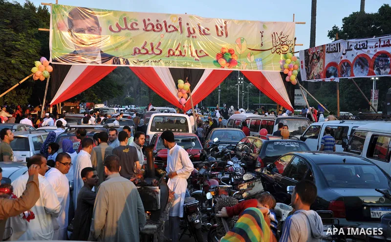 Supporters of ousted Egyptian President Mohamed Morsi during Eid Al-Fitr prayer at Al-Nahda square where thousands of Mohamed Morsi's supporters continued their open-ended sit-in since June 28 in Cairo, Egypt, on Aug. 8,...