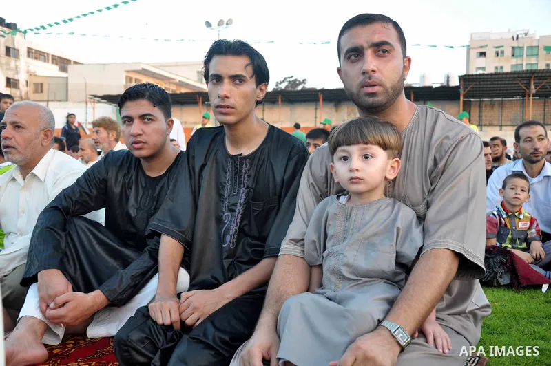 Palestinians attend the early morning Eid Al-Fitr prayer in the Gaza City on August 8, 2013. Muslims around the world are celebrating Eid al-Fitr this week, marking the end of holiest month of Ramadan during which follow...