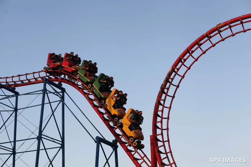 Palestinians enjoy a ride in an amusement park on the third day of Eid al-Fitr, marking the end of Islam's fasting holy month of Ramadan, in Gaza City on August 10, 2013. Photo by Ashraf Amra