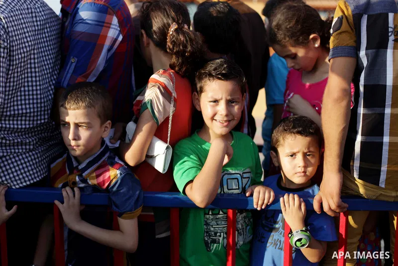 Palestinians enjoy a ride in an amusement park on the third day of Eid al-Fitr, marking the end of Islam's fasting holy month of Ramadan, in Gaza City on August 10, 2013. Photo by Ashraf Amra