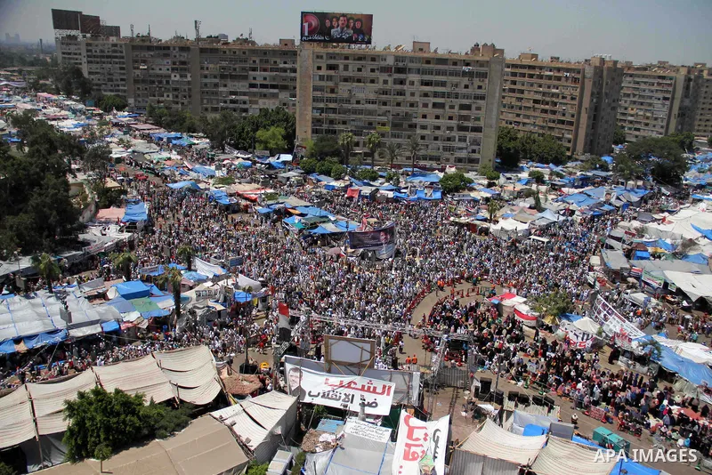 Members of the Muslim brotherhood and supporters of ousted Egyptian President Mohammed Morsi attend a sit-in outside the Rabaa al-Adawiya mosque in cairo on August 11, 2013. Morsi supporters hunker down behind makeshift...