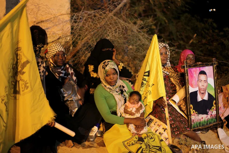 People wait near Erez crossing between Israel and northern Gaza Strip, for the arrival of Palestinian prisoners due for release from Israeli jails to help underpin renewed peace talks, August 14, 2013. Israel was set to...