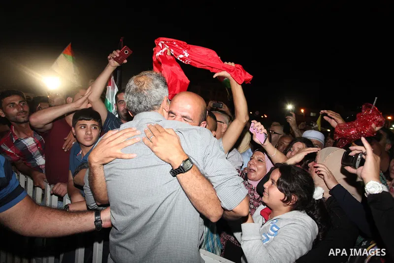 A released Palestinian prisoner is welcomed at the headquarters of Palestinian President Mahmoud Abbas in the West Bank town of Ramallah, 14 August 2013. Israel released 26 long-held Palestinian prisoners in a planned go...