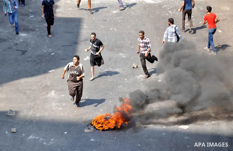 Supporters of ousted President Mohamed Morsi clash with Egyptian riot police on a street leading to Rabaa al-Adawiya square in Cairo on August 14, 2013 as security forces backed by bulldozers moved in on two huge pro-Mor...