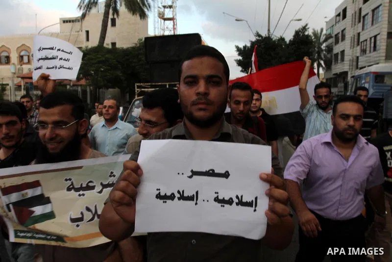 Palestinian supporters of ousted Egyptian president Mohamed Morsi take part in a protest against the violence in the Egyptian capital on August 14, 2013, in Gaza City. Egypt's bloody crackdown on supporters of ousted pre...