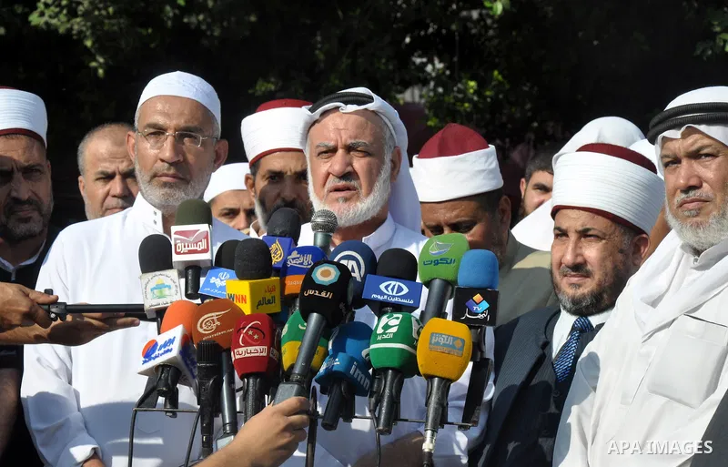 Chairman of the Palestine Scholars Association Sheikh Salem Salameh, speaks to media during a protest against the violence in the Egyptian capital on August 14, 2013, in Gaza City. Egypt's bloody crackdown on supporters...