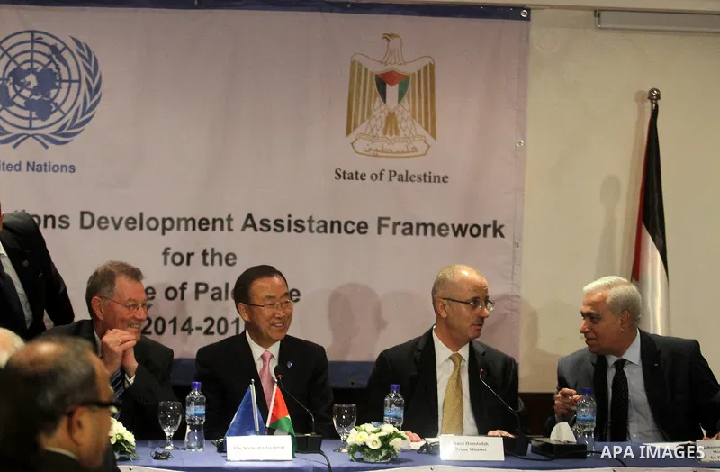 U.N. Secretary-General Ban Ki-moon (2nd L) looks on during a press conference with Palestinian Prime Minister Rami Hamdallah (2nd R) in the West Bank city of Ramallah August 15, 2013. Ban Ki-moon urged Israelis and Pales...