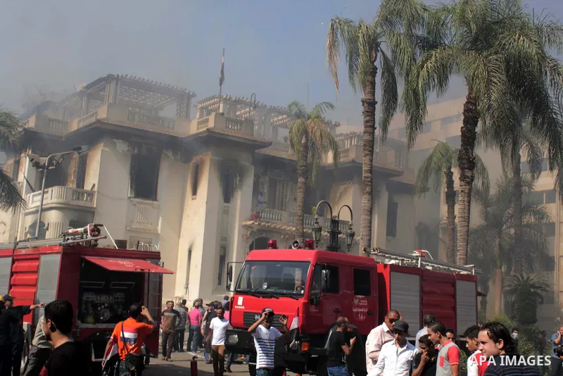 Egyptians try to put out a fire in a government building that was set ablaze in Giza's district of Cairo, August 15, 2013. Hundreds of supporters of Egypt's Muslim Brotherhood stormed a government building in Cairo on Th...