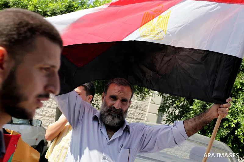 Palestinians protester carry a placard and gestures during a rally in support of ousted Egyptian president Mohamed Morsi, in Gaza City on August 19, 2013. Egypt closed its Rafah border crossing in Sinai with the Palestin...